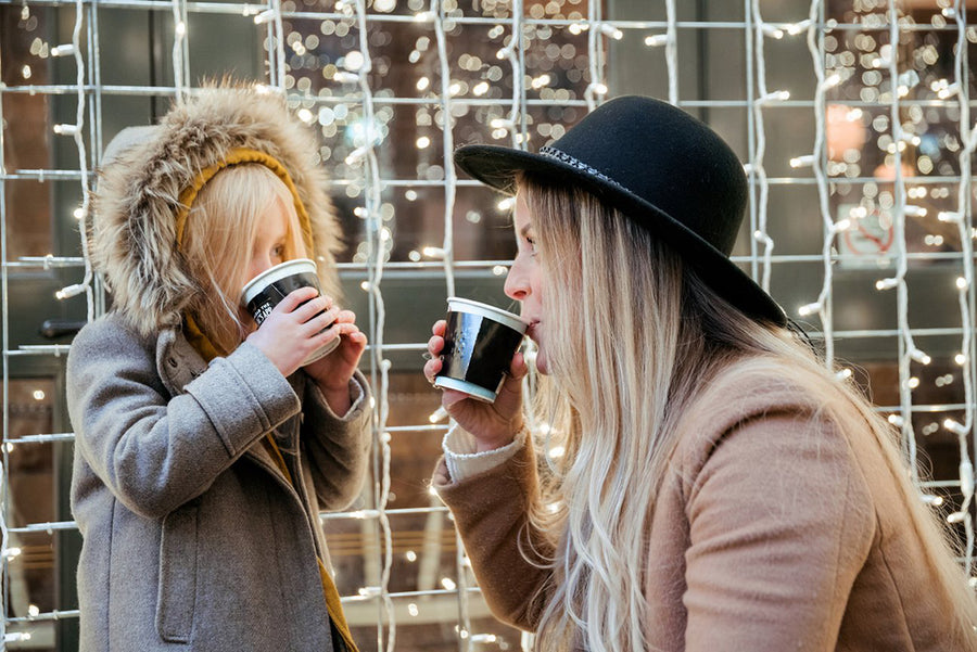 Mom and daughter having hot cocoa together